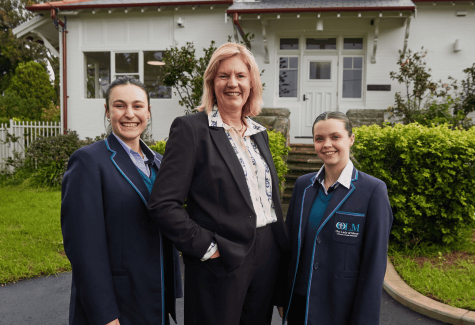 A photo showing Principal Christine Harding with students outside Coolangatta House